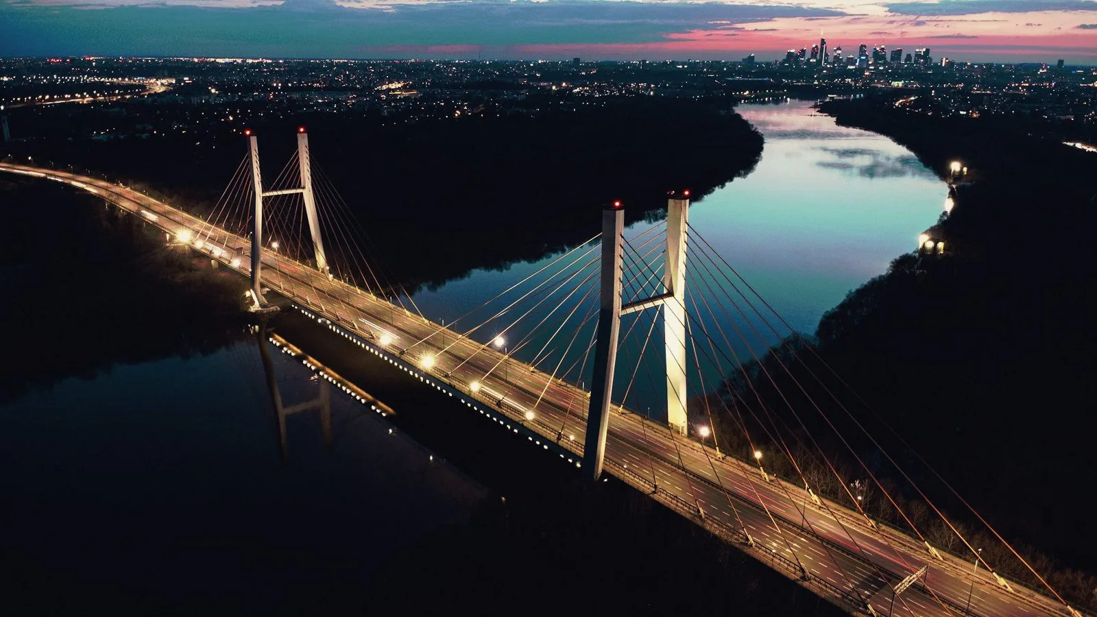 A bridge crossing a river at dusk.