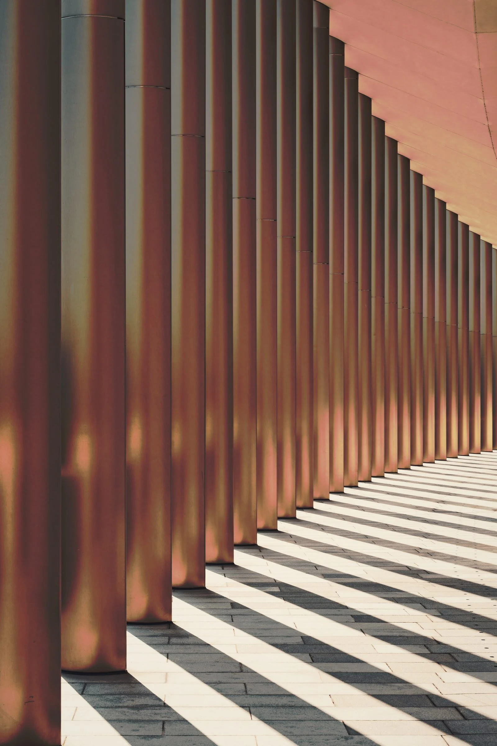 Bronze pillars in raking light.